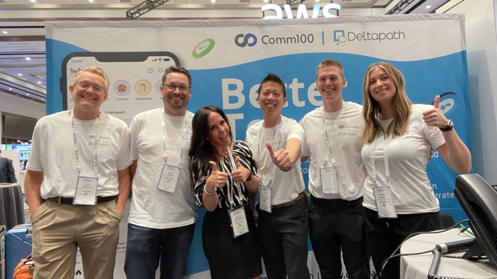 Comm100's team at their booth at CCW Vegas