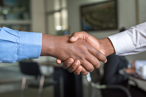 Employer and employee shaking hands after a successful high volume hiring event