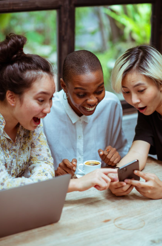 women showing excitment over news on phone