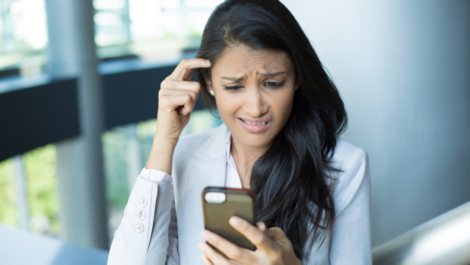 stressed woman looking at phone