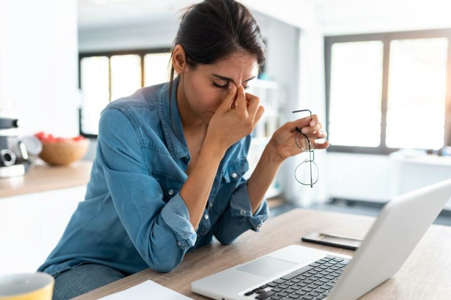 woman working on laptop stressed