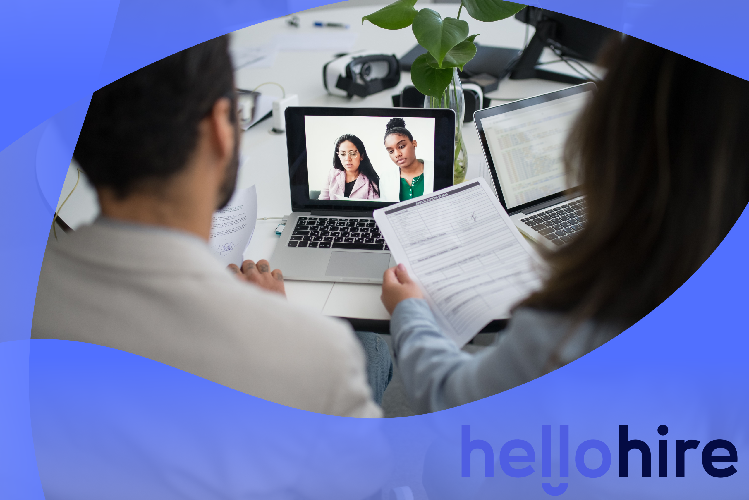 Two home care recruiters reviewing a caregiver application on a laptop
